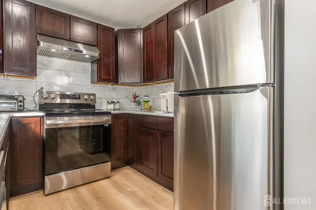 a kitchen with a refrigerator sink and stove