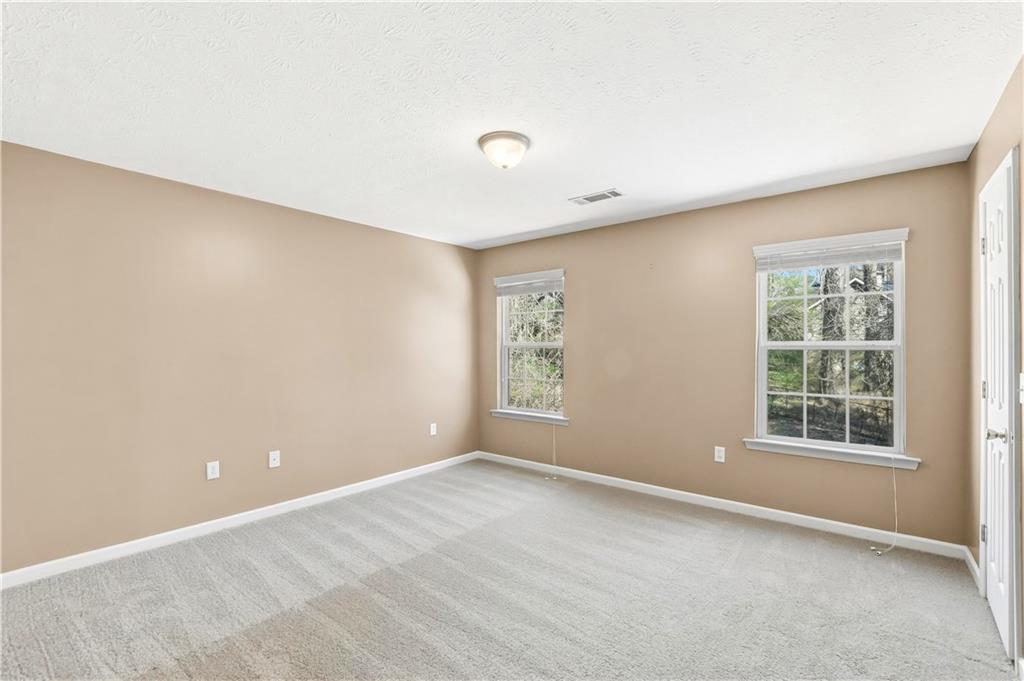 5976 Bowers Road Stone Mountain, GA 30087 - Photo 19 of 31 an empty room with windows and closet