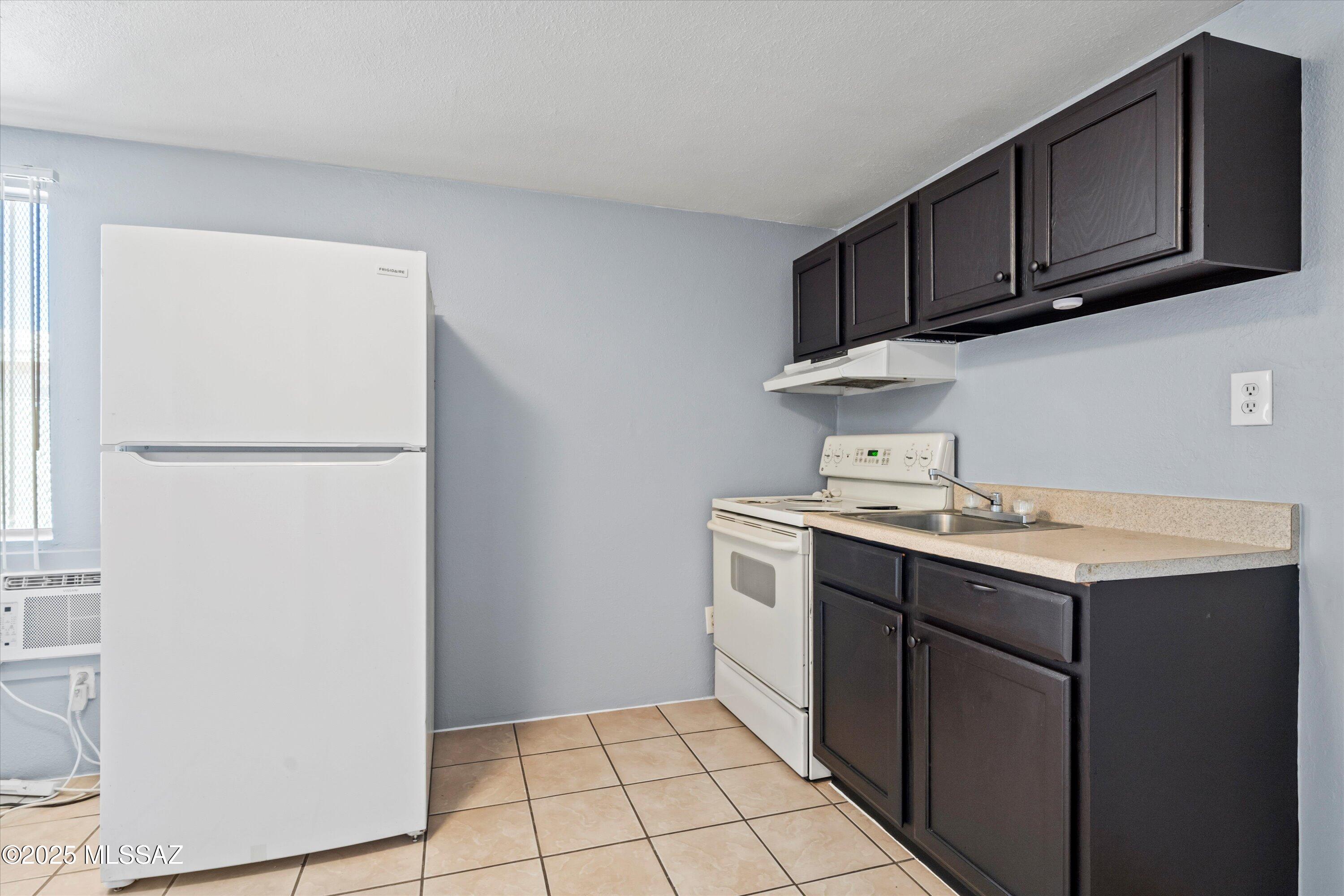 1227 East Ginter Road Tucson, AZ 85706 - Photo 5 of 18 a utility room with cabinets washer and dryer