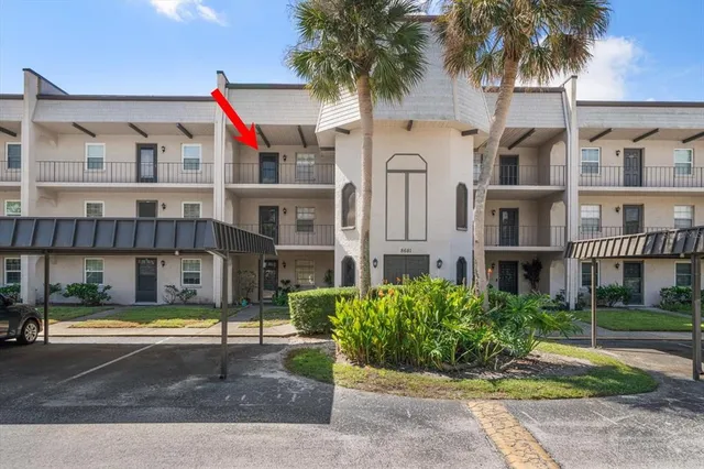 a front view of residential houses with yard and green space
