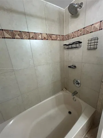 a bathroom with a bathtub and shower