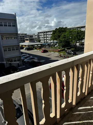 a vase with flowers on a deck