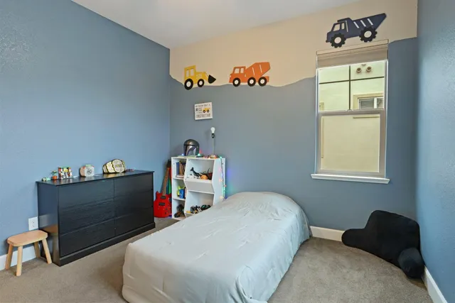 a bedroom with a bed and window