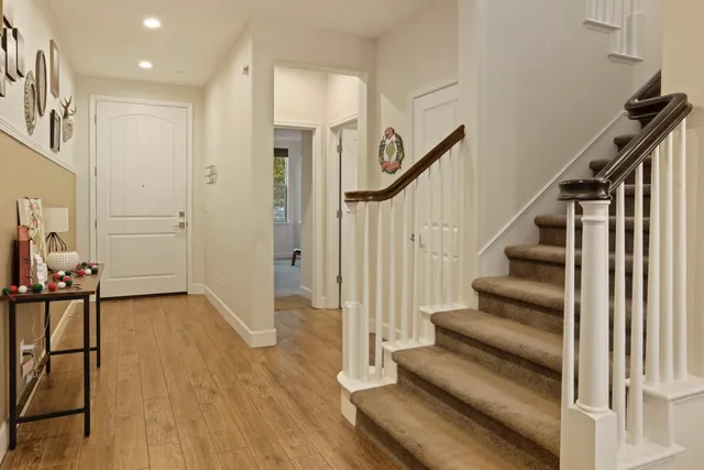 a view of entryway with wooden floor and stairs