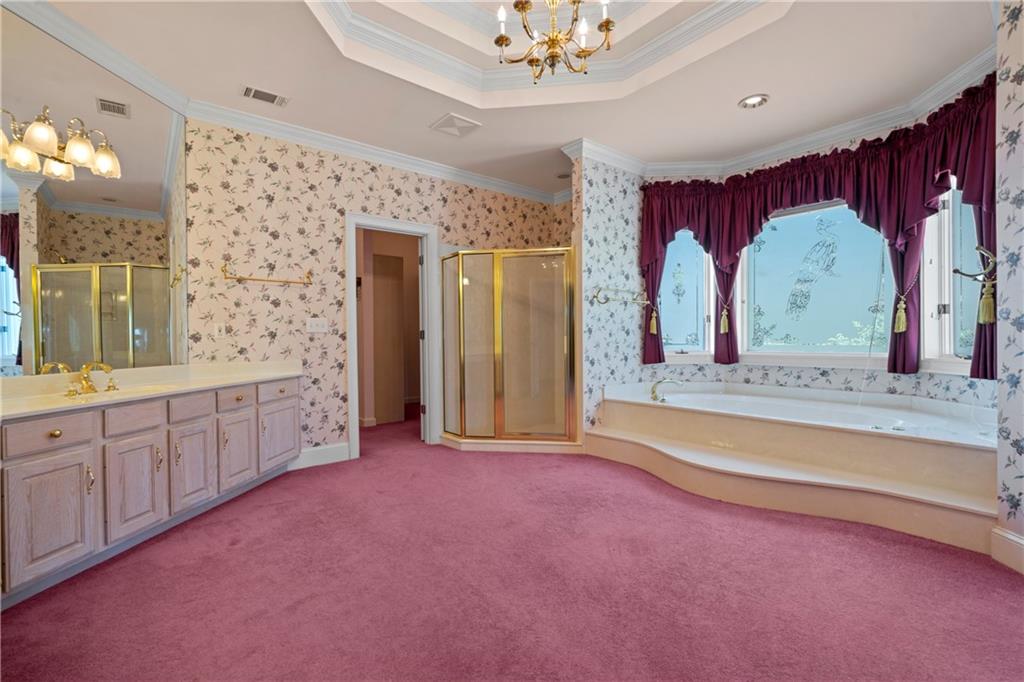 5414 Price Road Gainesville, GA 30506 - Photo 45 of 82 a spacious bathroom with a granite countertop sink a mirror and shower