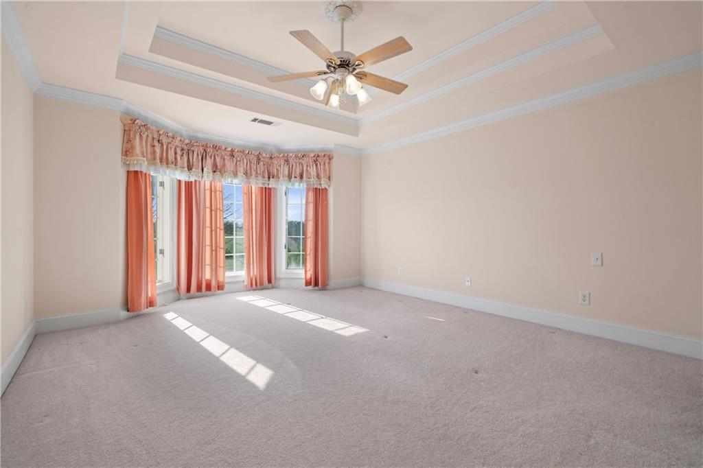 5414 Price Road Gainesville, GA 30506 - Photo 52 of 82 an empty room with windows and chandelier fan