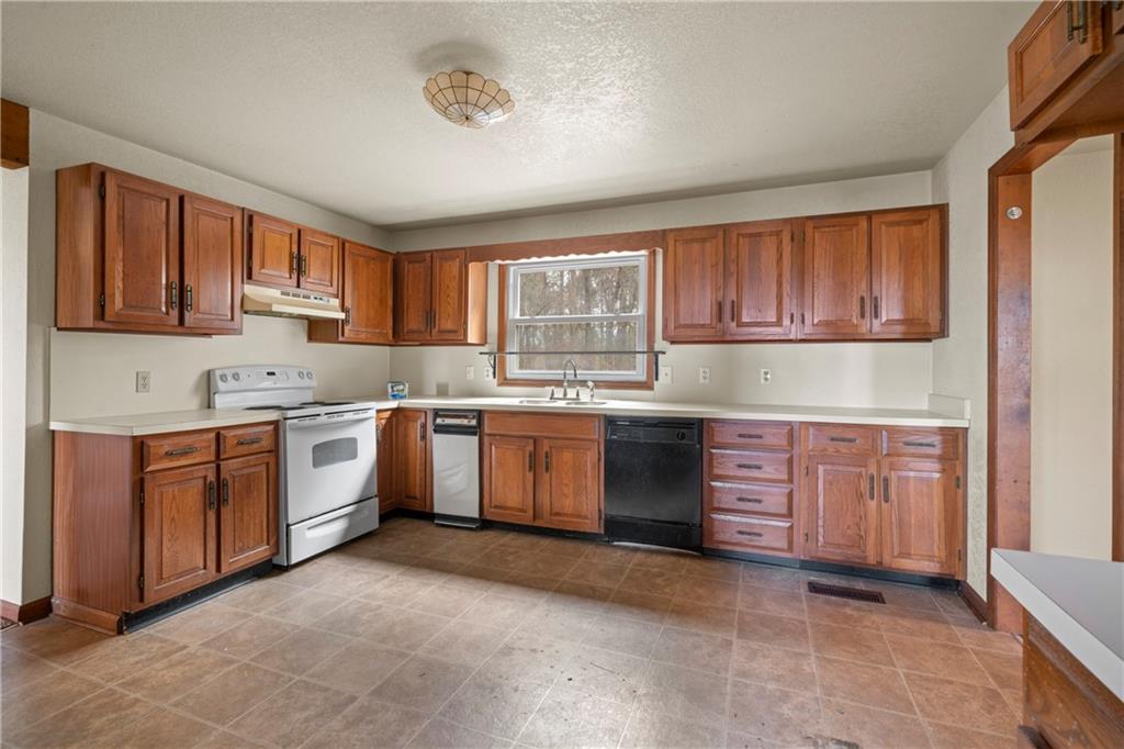 5414 Price Road Gainesville, GA 30506 - Photo 73 of 82 a kitchen with granite countertop a sink cabinets stainless steel appliances and a window