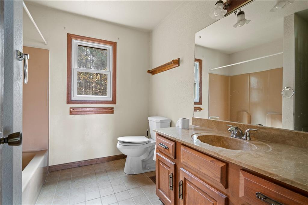 5414 Price Road Gainesville, GA 30506 - Photo 74 of 82 a bathroom with a granite countertop sink mirror vanity and toilet