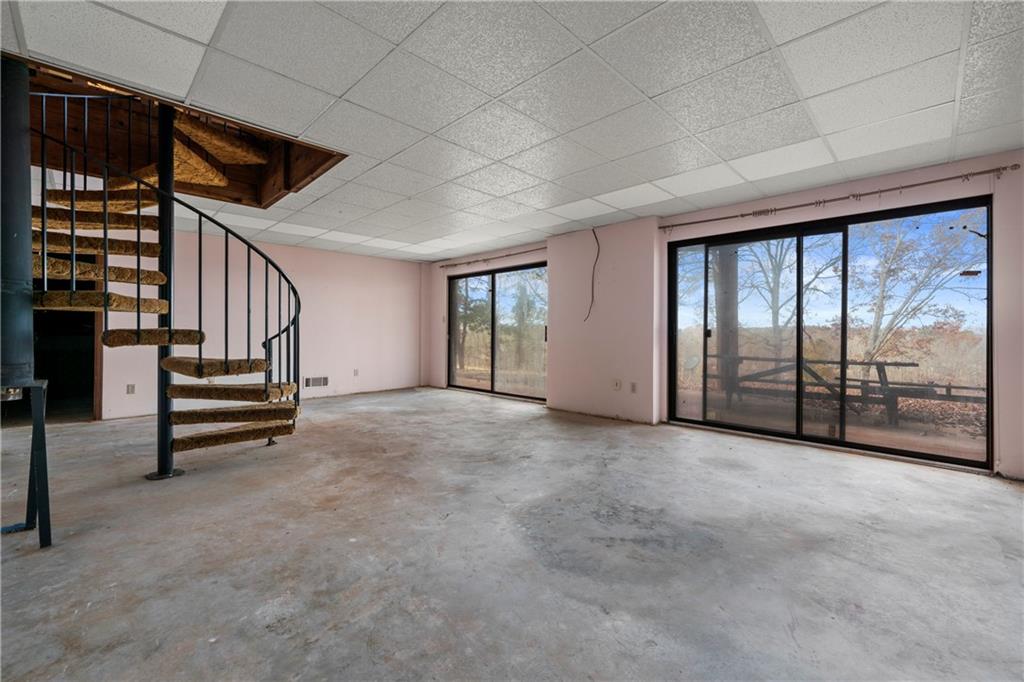 5414 Price Road Gainesville, GA 30506 - Photo 81 of 82 a view of an empty room with stairs wooden floor and door