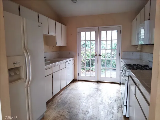 a kitchen with stainless steel appliances a refrigerator sink and stove