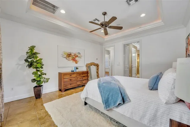 a bedroom with a bed and a potted plant