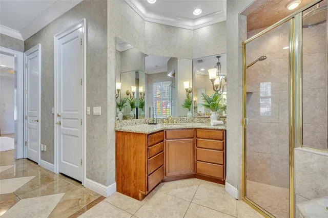 a bathroom with a granite countertop sink a mirror and a shower