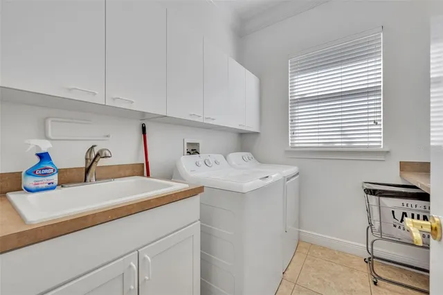 a utility room with sink dryer and washer