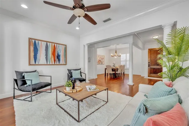 a living room with furniture and a painting on the wall
