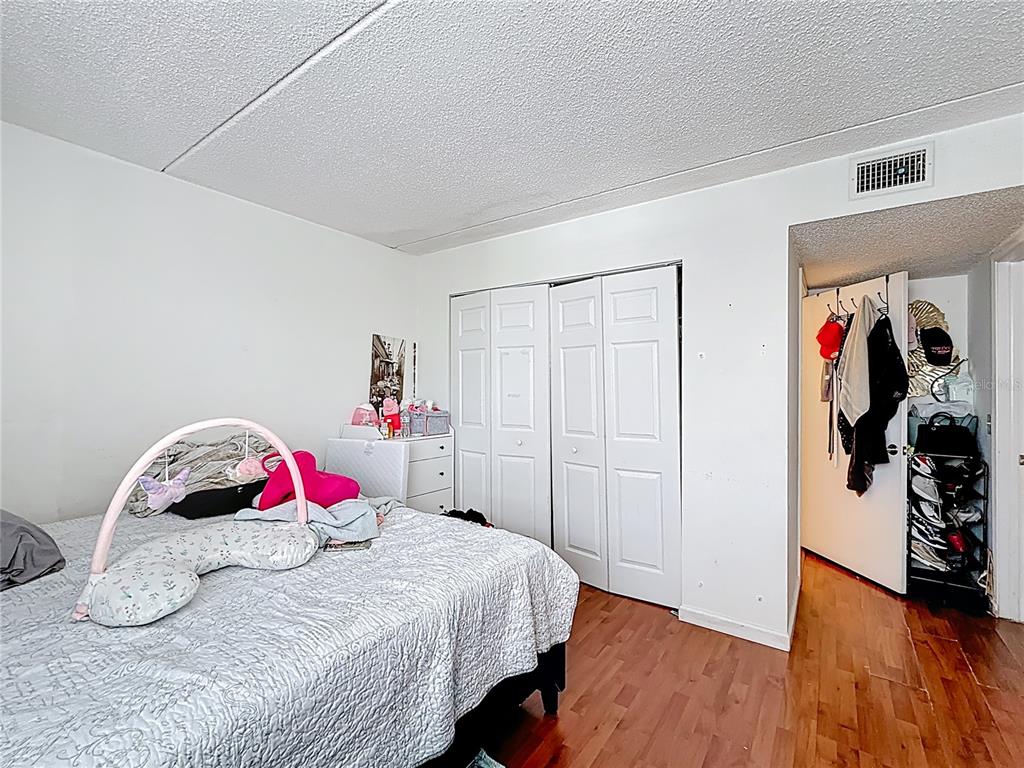 6065 Northwest 186th Street, Unit 312 Hialeah, FL 33015 - Photo 11 of 17 a bedroom with a bed and a closet