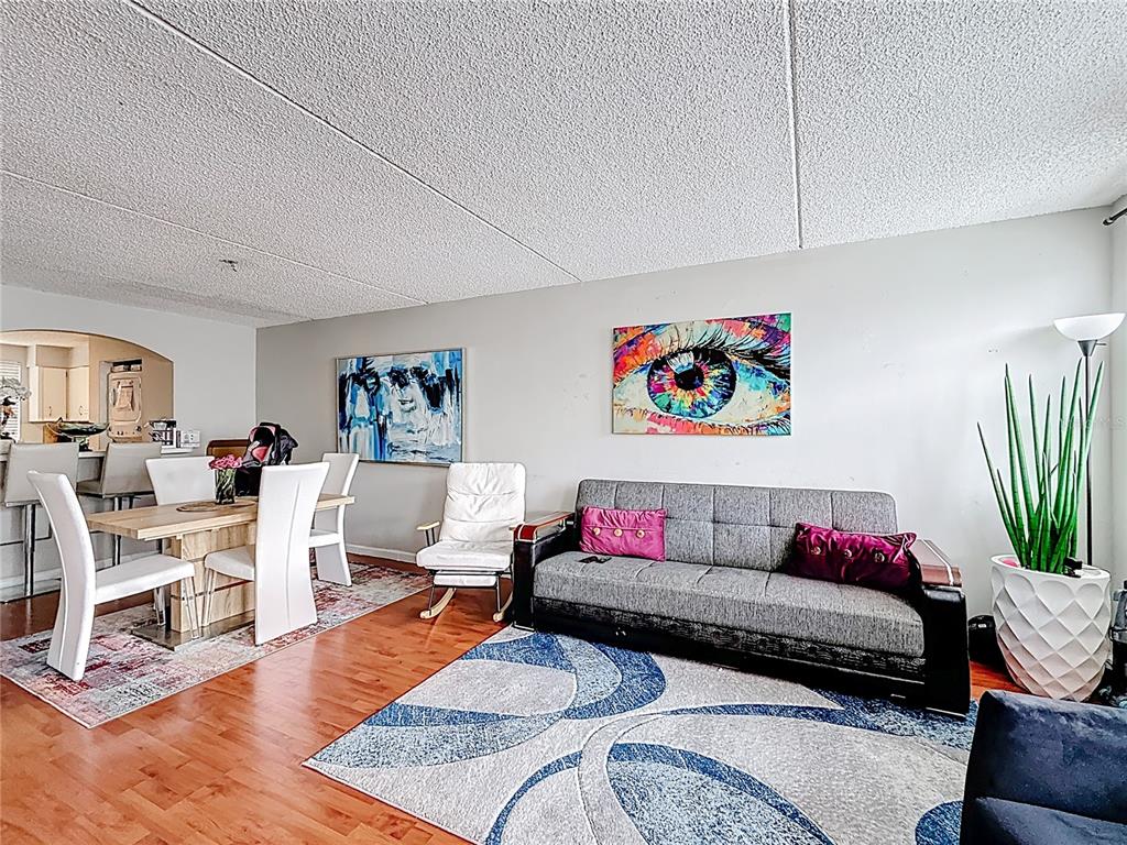 6065 Northwest 186th Street, Unit 312 Hialeah, FL 33015 - Photo 4 of 17 a living room with furniture rug and wooden floor