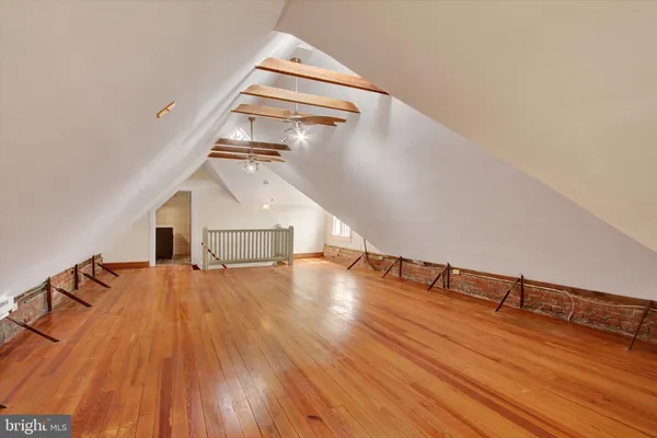 wooden floor with a ceiling fan and wooden floor