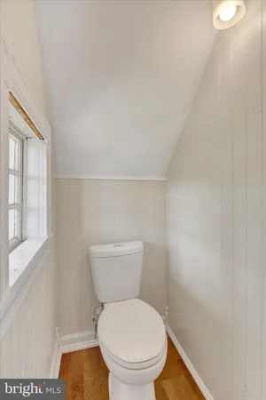 a white toilet sitting next to a window