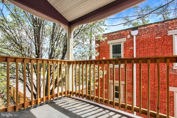 a view of a house with a small yard and wooden fence