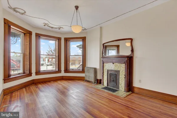 a view of a livingroom with a fireplace and wooden floor
