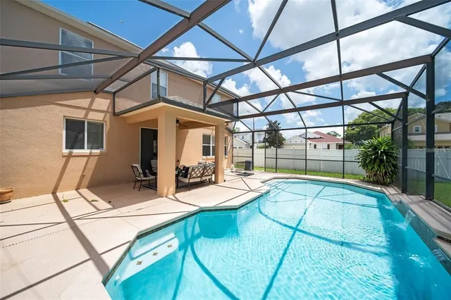 a view of a patio with a table and chairs under an umbrella