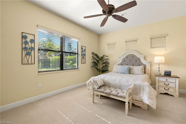 a bedroom with a bed couch and potted plant