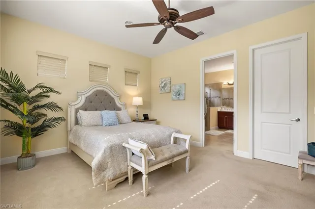 a bedroom with a bed and a flat tv screen in it