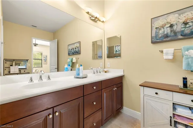 a bathroom with a double vanity sink mirror and double