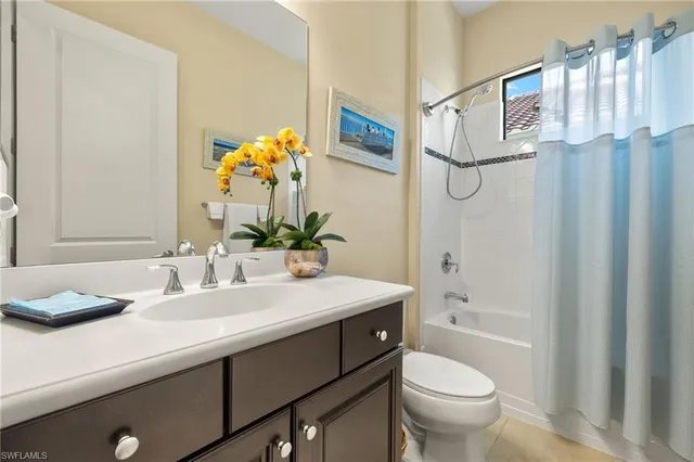 a bathroom with a sink vanity mirror and toilet