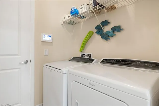 a living room with patio furniture and garden view