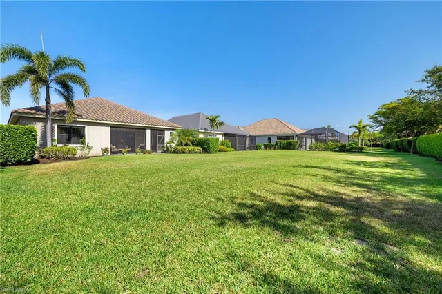 a view of yard with swimming pool and green space