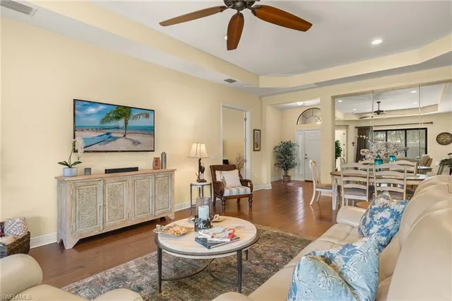 a living room with furniture kitchen view and a table