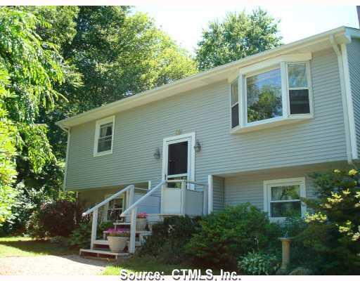 75 Stewart Road Stonington, CT 06379 - Photo 1 of 1 a house that has a tree in front of the house