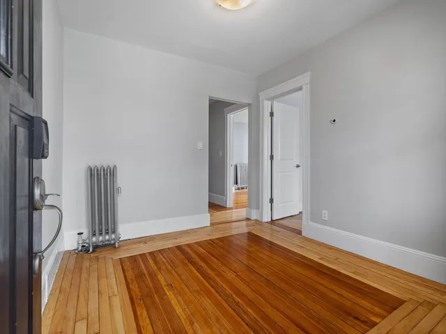 a view of a room with wooden floor