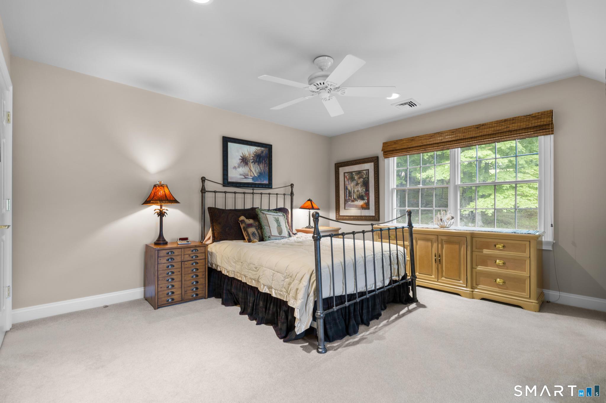 12 Logans Way Danbury, CT 06811 - Photo 26 of 40 a bed room with a bed and a baby crib
