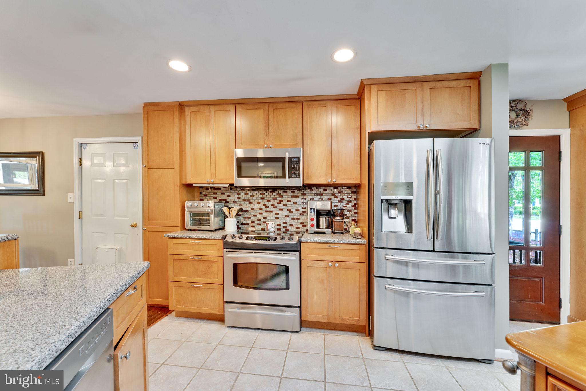 501 Ridge Road Southwest Vienna, VA 22180 - Photo 12 of 54 a kitchen with stainless steel appliances granite countertop a refrigerator and a stove top oven