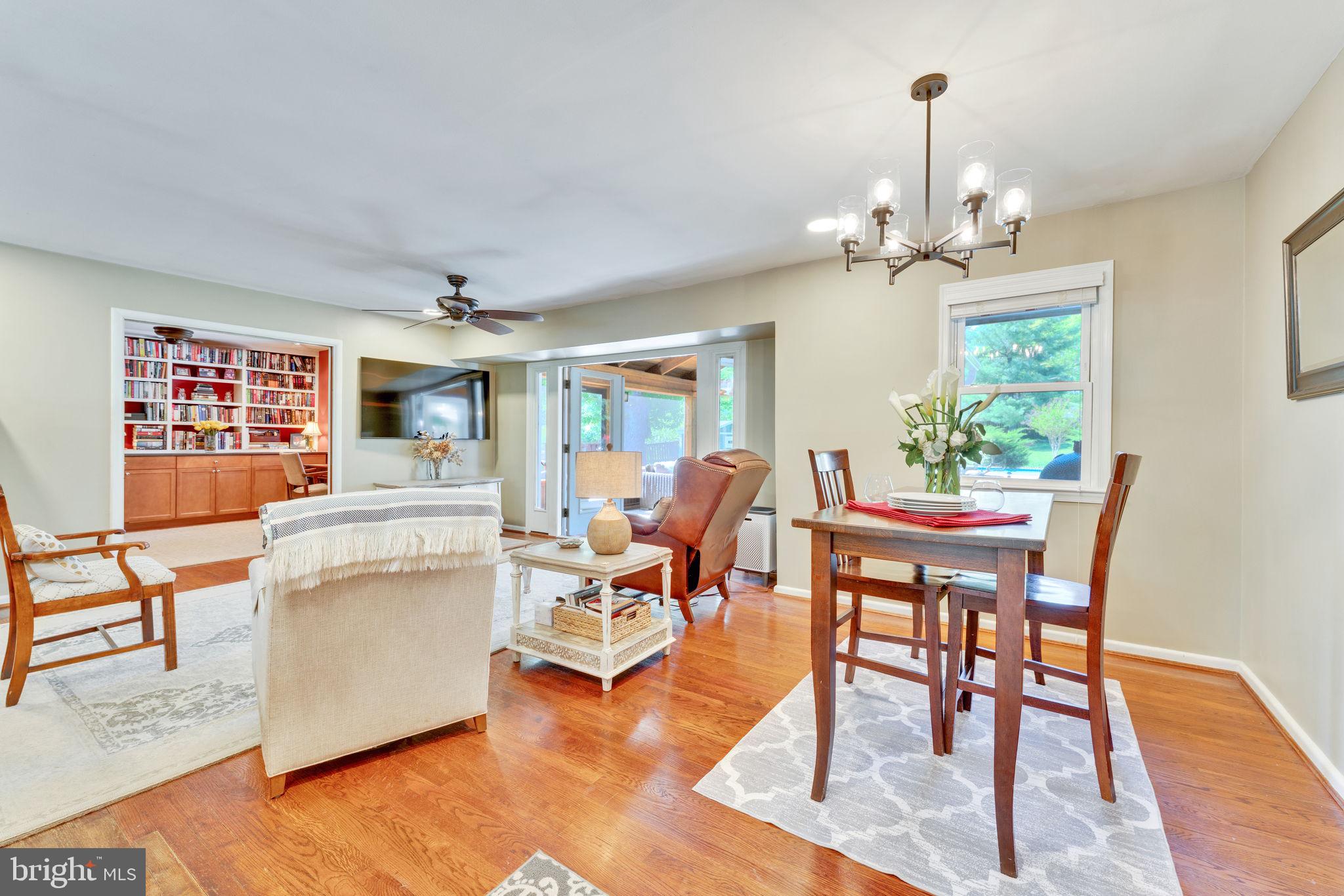501 Ridge Road Southwest Vienna, VA 22180 - Photo 16 of 54 a living room with furniture a chandelier and a dining table