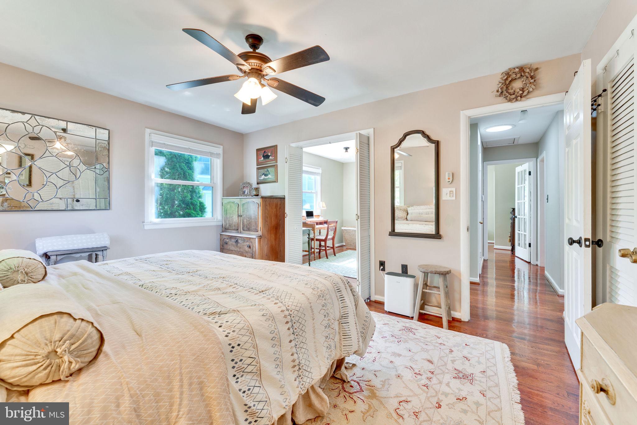 501 Ridge Road Southwest Vienna, VA 22180 - Photo 24 of 54 a spacious bedroom with a bed a dresser and wooden floor