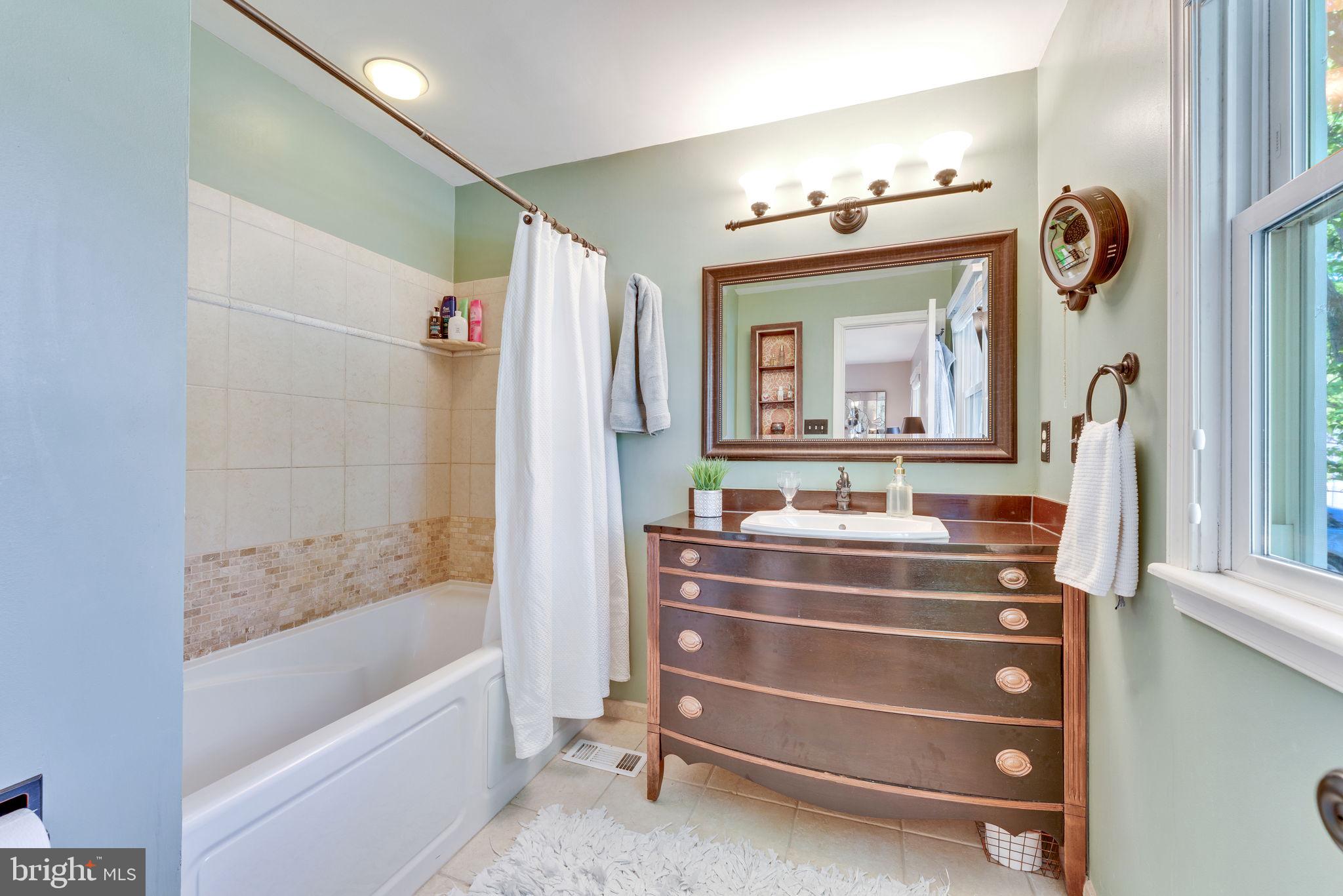 501 Ridge Road Southwest Vienna, VA 22180 - Photo 25 of 54 a bathroom with a sink mirror and a bathtub