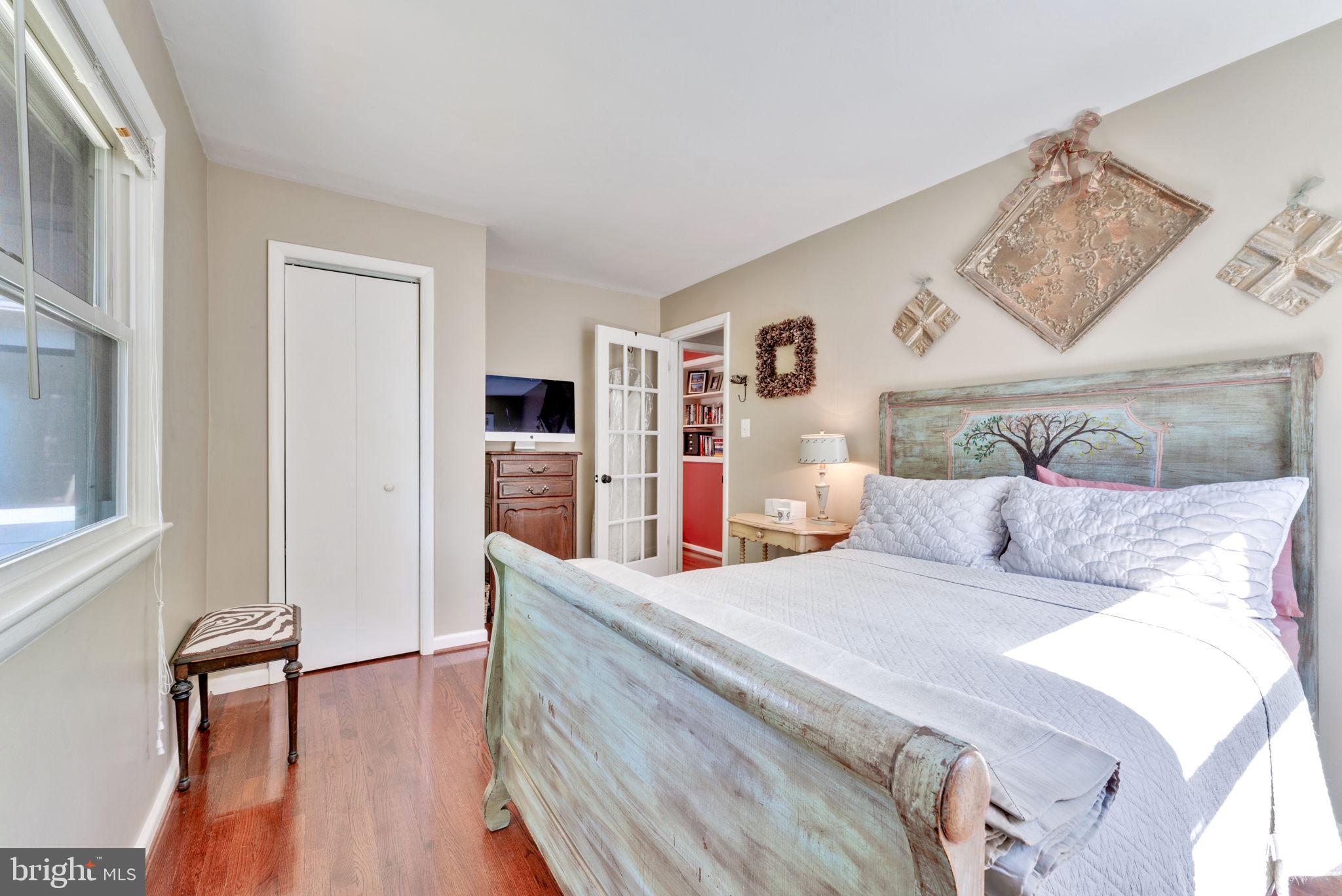 501 Ridge Road Southwest Vienna, VA 22180 - Photo 29 of 54 a bedroom with a large bed and a wooden floor