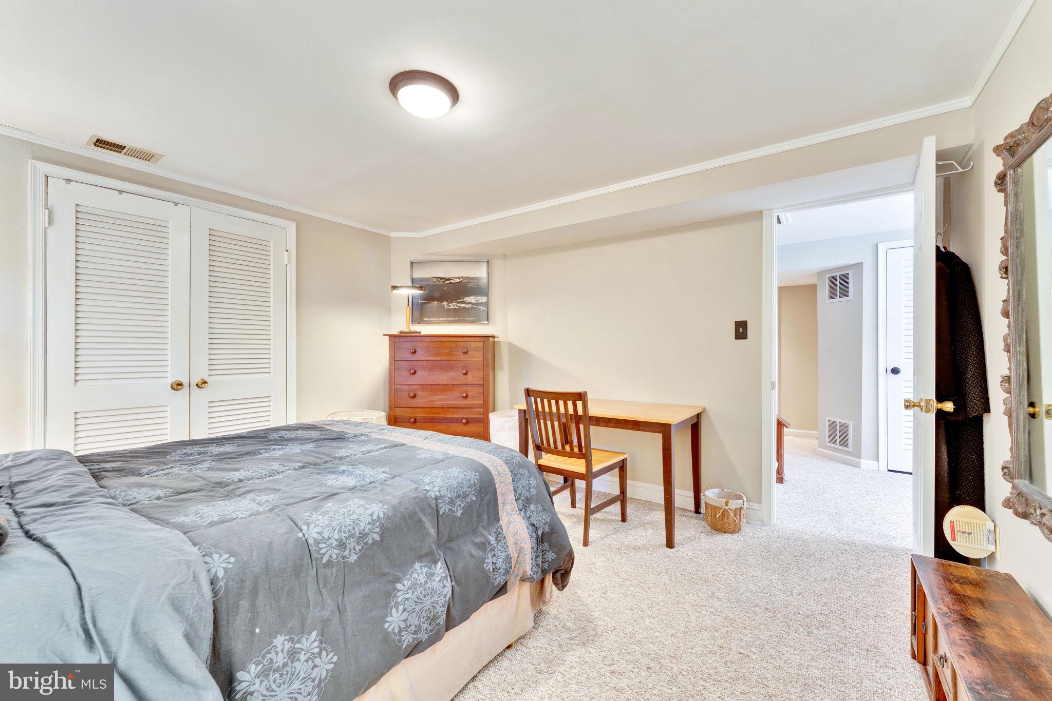 501 Ridge Road Southwest Vienna, VA 22180 - Photo 38 of 54 a bedroom with a bed and a chair with the wooden floor