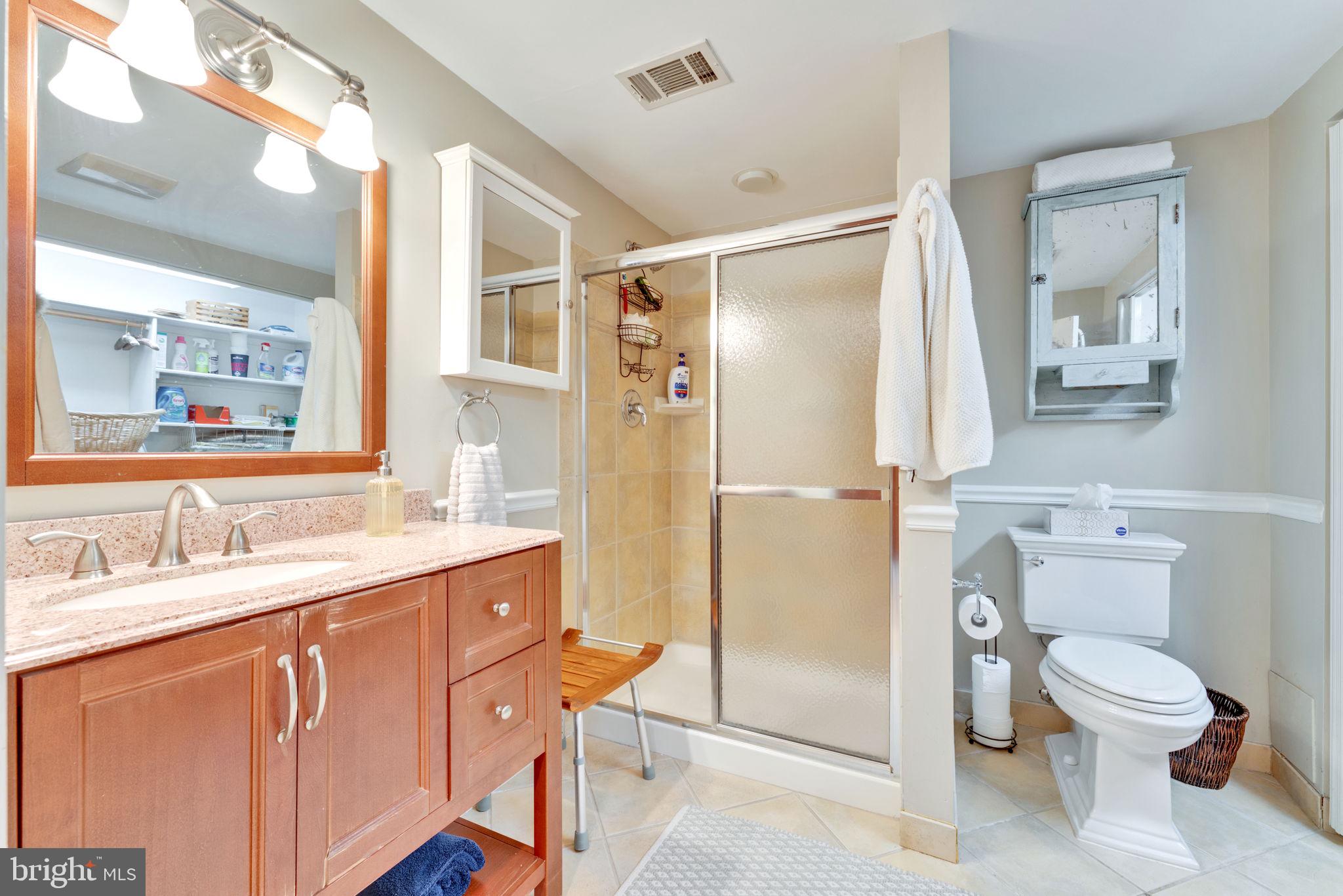 501 Ridge Road Southwest Vienna, VA 22180 - Photo 39 of 54 a bathroom with a granite countertop sink toilet and shower