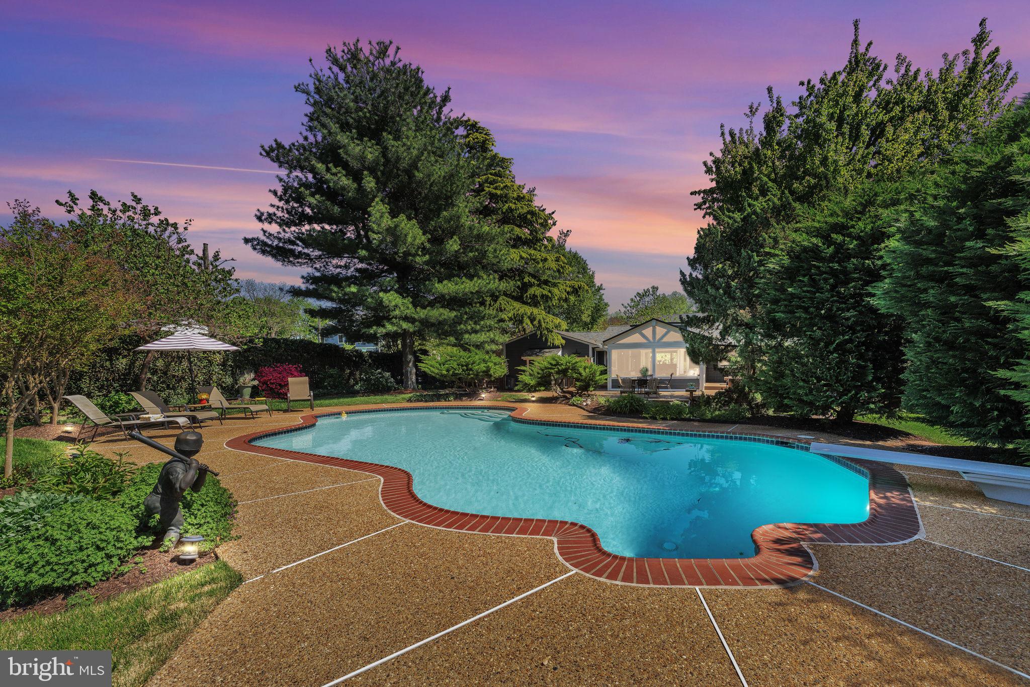 501 Ridge Road Southwest Vienna, VA 22180 - Photo 52 of 54 a view of a swimming pool and lounge chairs in patio