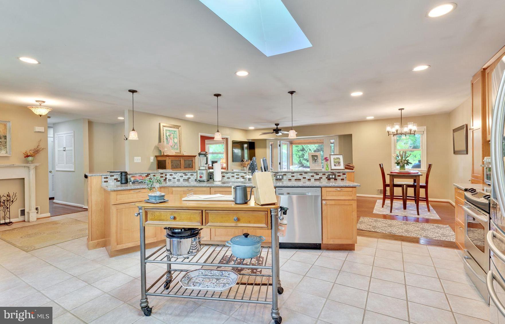 501 Ridge Road Southwest Vienna, VA 22180 - Photo 10 of 54 a kitchen with a dining table chairs and white appliances