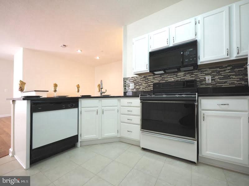1705 Lake Shore Crest Drive, Unit 23 Reston, VA 20190 - Photo 17 of 45 a kitchen with a stove and a microwave