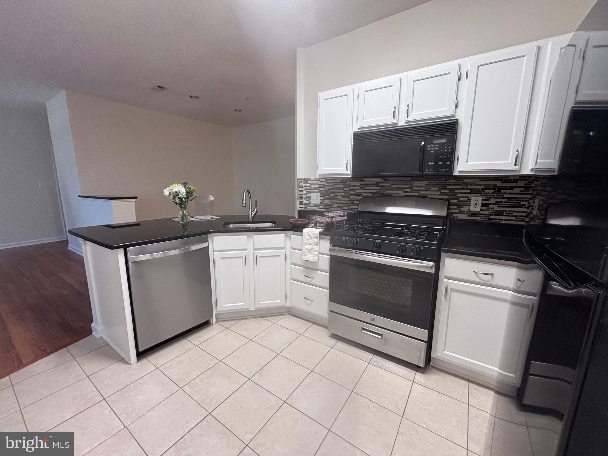 1705 Lake Shore Crest Drive, Unit 23 Reston, VA 20190 - Photo 19 of 45 a kitchen with a sink stove and microwave