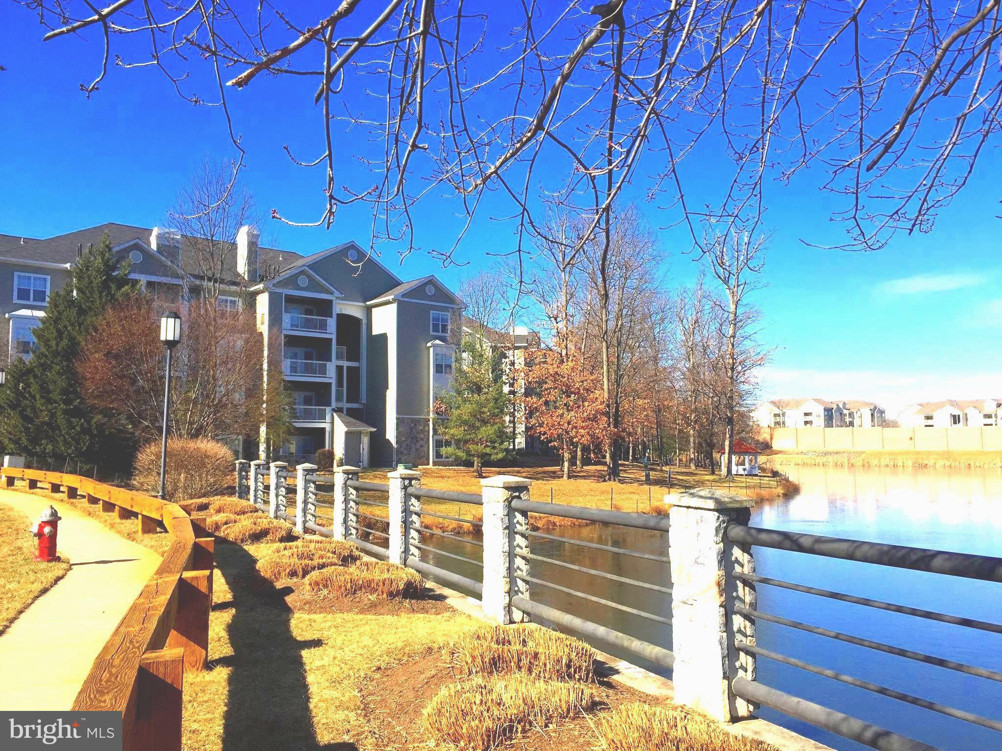 1705 Lake Shore Crest Drive, Unit 23 Reston, VA 20190 - Photo 2 of 45 a view of a swimming pool with an outdoor seating