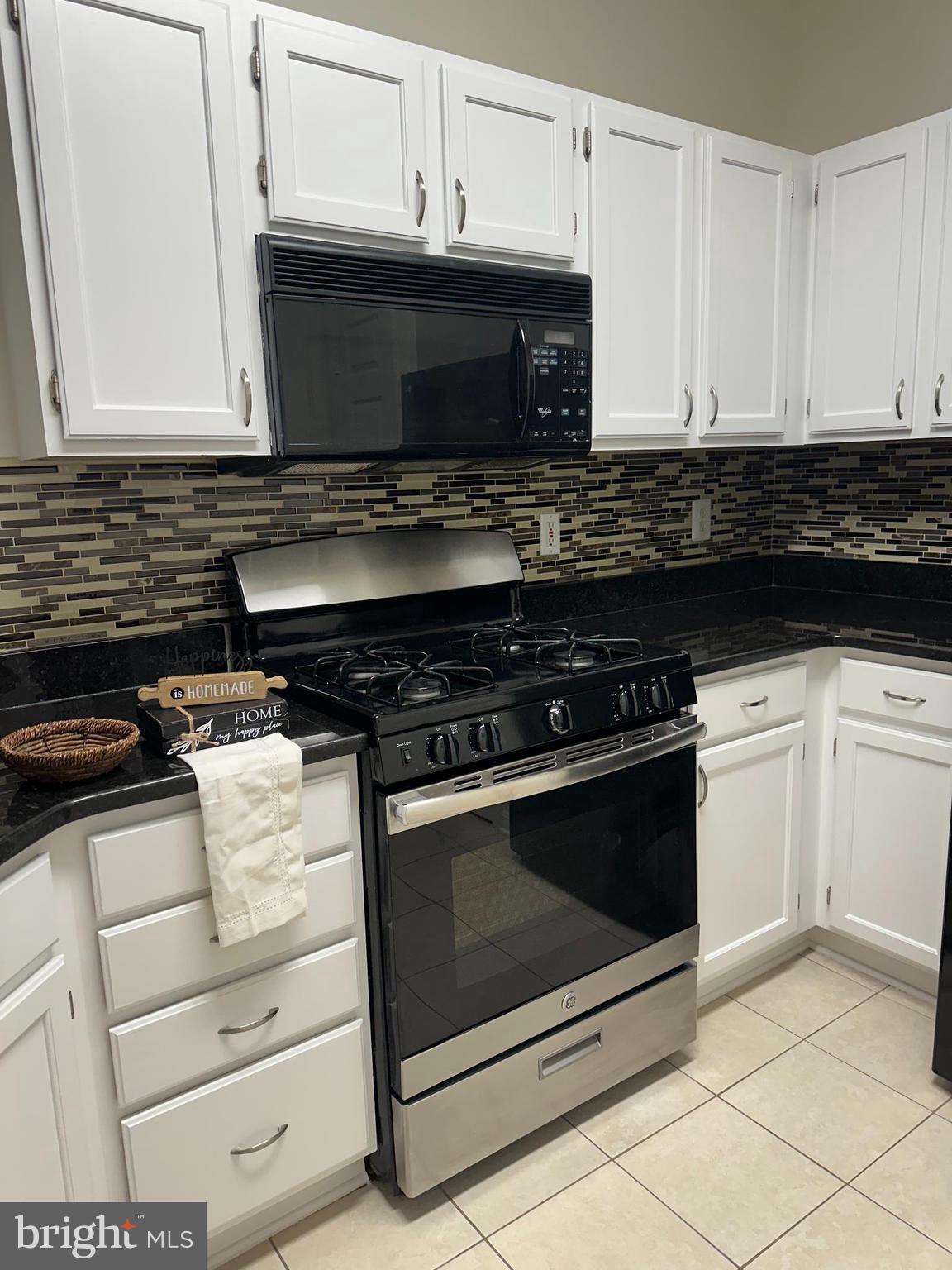 1705 Lake Shore Crest Drive, Unit 23 Reston, VA 20190 - Photo 22 of 45 a kitchen with granite countertop a stove and a microwave