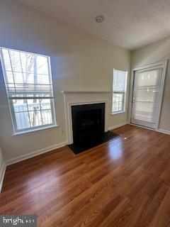 1705 Lake Shore Crest Drive, Unit 23 Reston, VA 20190 - Photo 24 of 45 an empty room with wooden floor fireplace and windows