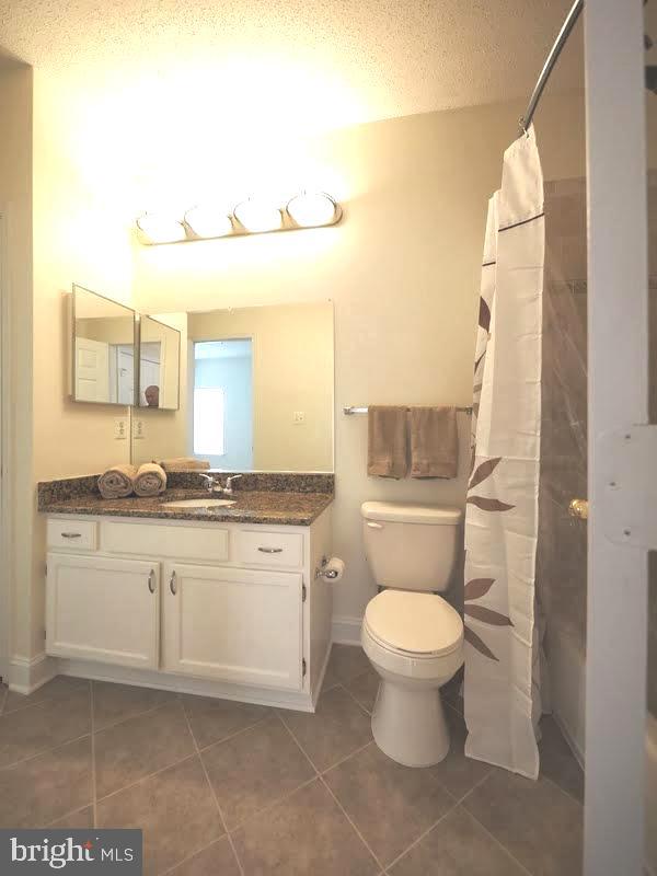 1705 Lake Shore Crest Drive, Unit 23 Reston, VA 20190 - Photo 35 of 45 a bathroom with a granite countertop toilet sink and mirror